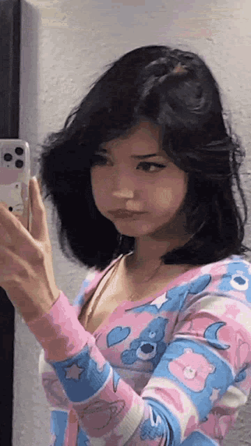 a girl is taking a picture of herself in a mirror with her phone