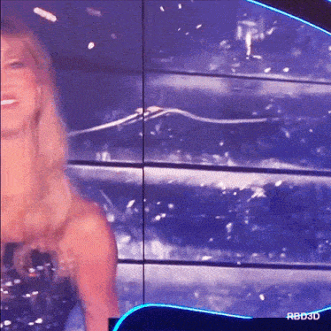 a woman is standing in front of a screen that says rbd3d on it