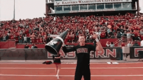 a man in an eastern washington university t-shirt holds a megaphone