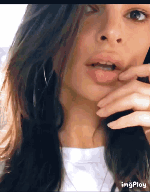 a close up of a woman 's face with the words imgplay visible