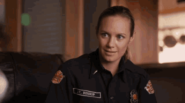 a woman in a firefighter uniform has the name lt. bishop on the patch