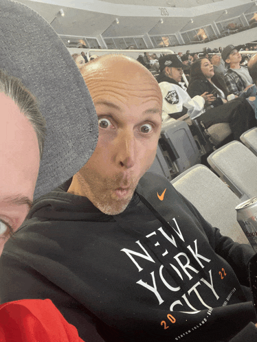 a man wearing a black new york city shirt