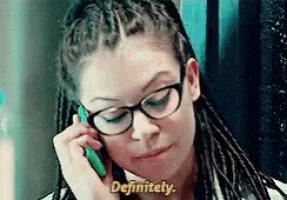 a woman wearing glasses is talking on a cell phone and says definitely