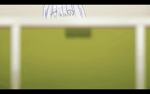 a blurry picture of a girl behind a white fence