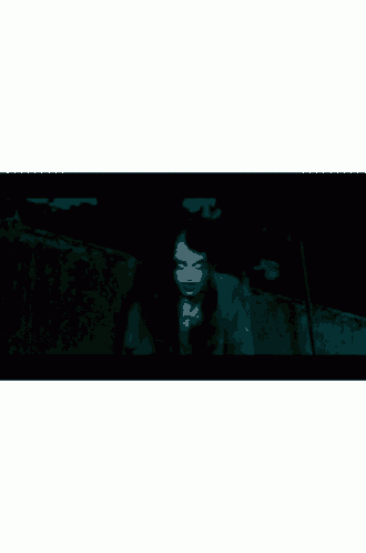 a close up of a scary face with white eyes and a black background