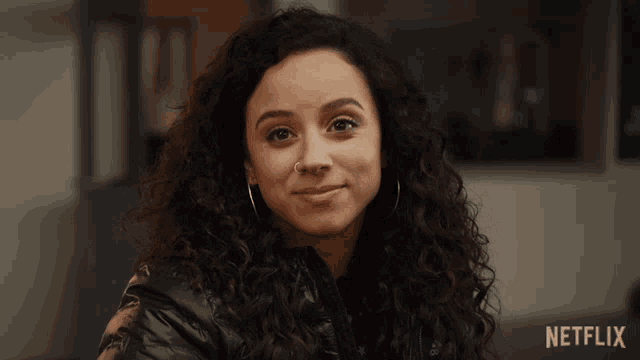 a close up of a woman 's face with a netflix logo in the background