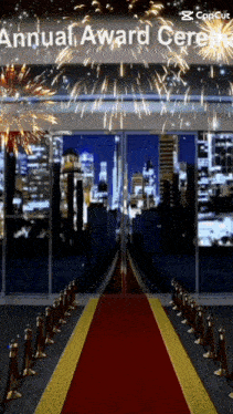 a red carpet leading to an award ceremony with fireworks in the background