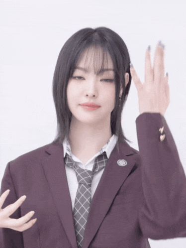 a girl wearing a suit and tie with a badge that says ' a '