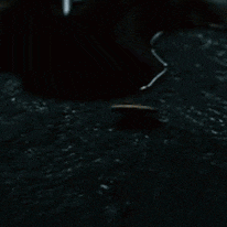 a coin with a smiley face on it is floating on the water .