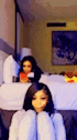 a blurry picture of a woman sitting on the floor in a hotel room .