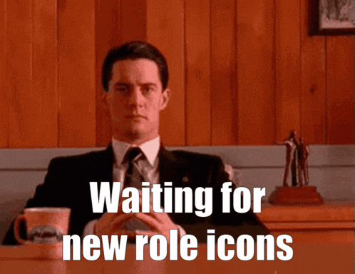 a man sitting at a table with the words waiting for new role icons