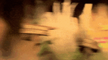 a blurry picture of a person holding a stack of cards