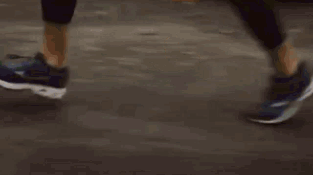 a woman is running in front of a house in a residential area .