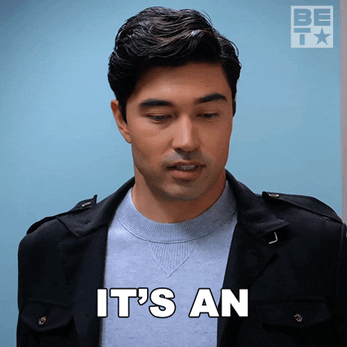 a man says " it 's an " in front of a blue wall
