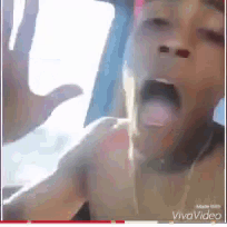 a close up of a person 's face in a car with their mouth open