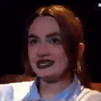 a close up of a woman 's face with dark lipstick on .