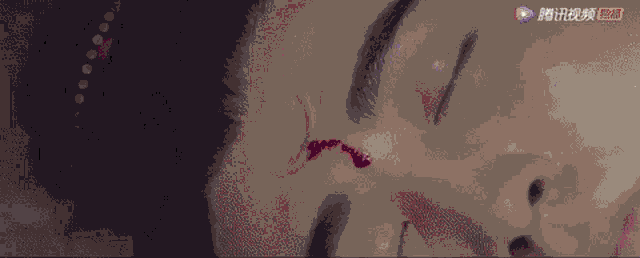 a close up of a man 's face with blood on his forehead .
