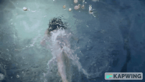 a person is swimming in a pool with the word kapwing on the bottom right