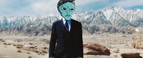 a man in a suit and tie with a blue alien head