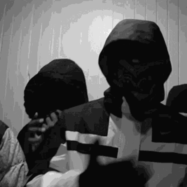 a man in a hooded jacket has the letter l on his jacket