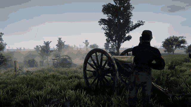 a man standing in a field with a cannon