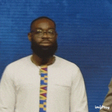 a man with a beard and glasses is being touched by another person .