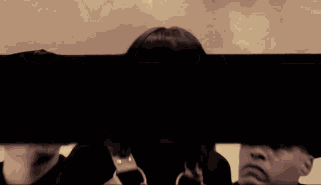 a woman with a fringe is surrounded by police officers