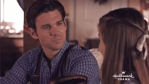 a man and a woman are looking at each other in a hallmark drama scene