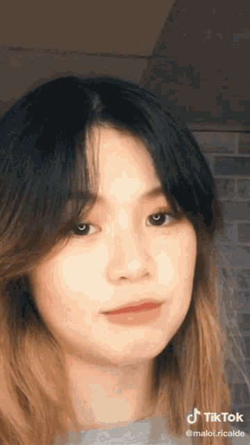 a close up of a woman 's face with a tiktok watermark