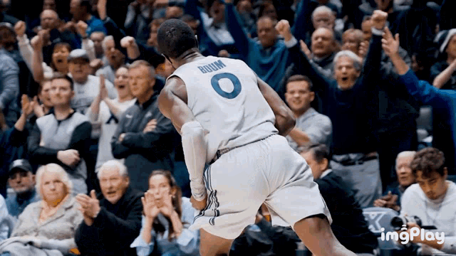 a basketball player with the number 0 on his jersey is jumping in the air