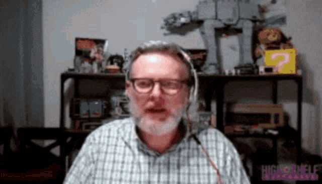 a man wearing headphones and a plaid shirt with the word high on the bottom