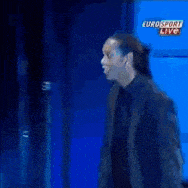 a man stands in front of a blue background with eurosport live written on it