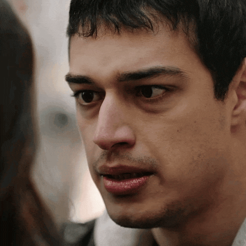a close up of a man looking at a woman