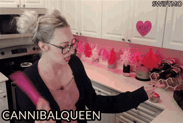 a woman standing in a kitchen with the word cannibalqueen on the bottom