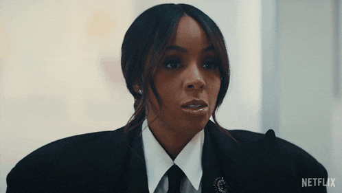 a woman in a suit and tie with a netflix logo on the bottom right