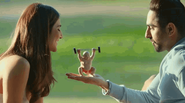 a man is holding a small chicken with a barbell on its head