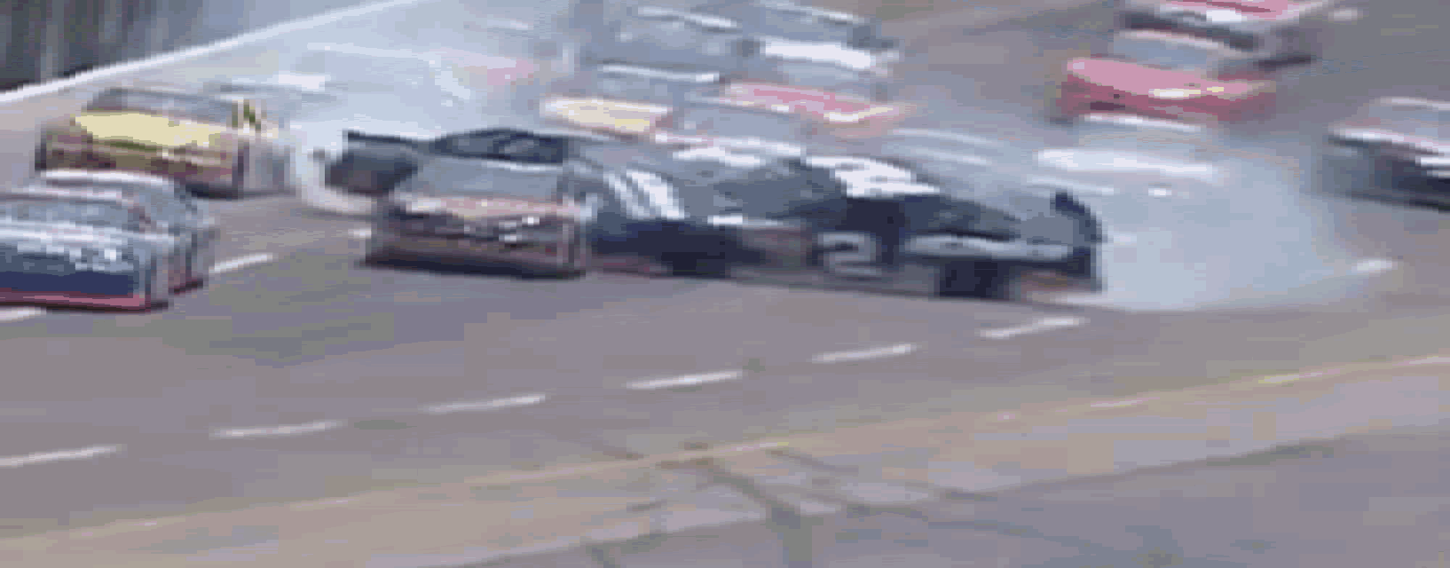 a race car with the number 10 on the side is going down the track