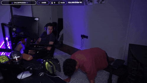 a man is doing push ups in front of a jbl quantum monitor