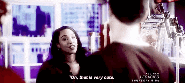 a woman is talking to a man in a store and saying `` oh , that is very cute '' .