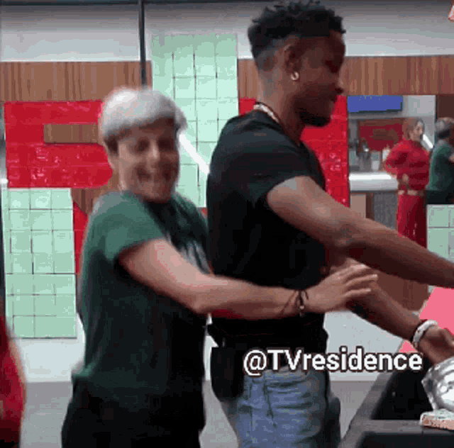 a man and a woman are hugging in a room with the words @tvresidence written on the bottom