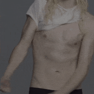 a shirtless man with long blonde hair is wearing a silver bracelet on his wrist