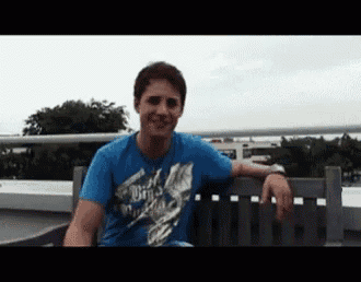 a man wearing a blue shirt that says ' birds ' on it