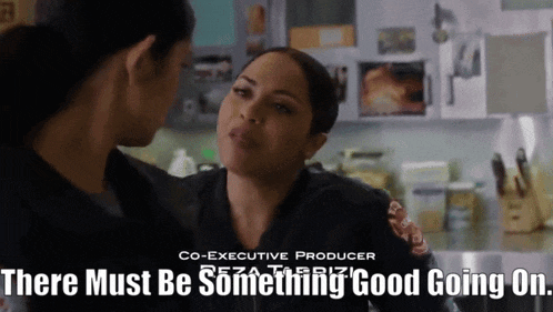 two women are talking in a kitchen with the words " there must be something good going on "