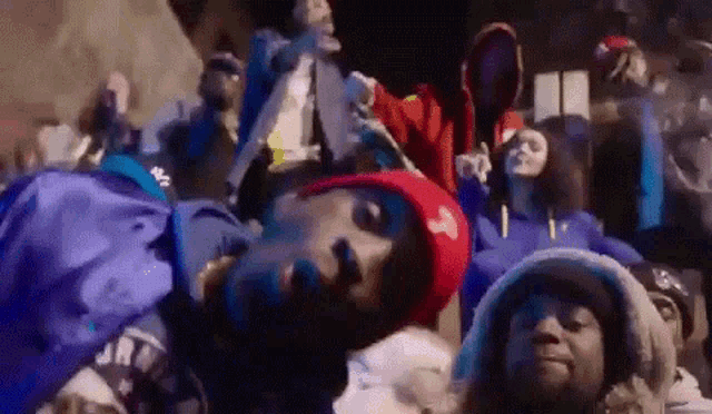 a group of people are laying on top of each other on a stage .