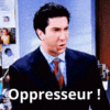a man in a suit and tie is standing in front of a microphone and saying oppresseur .