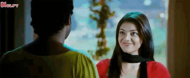a man and a woman are looking at each other and the words kulfy are on the bottom of the screen