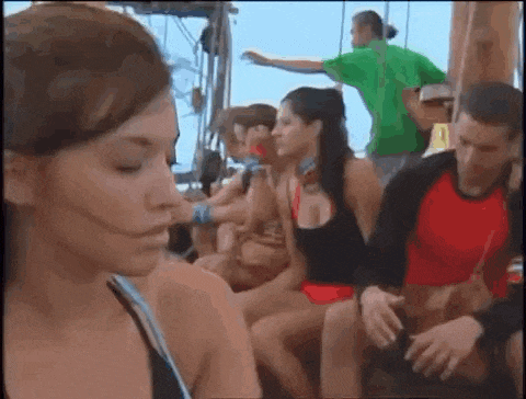 a group of people are sitting on a boat and a woman is looking at the camera .