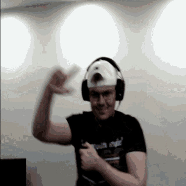 a man wearing headphones and a hat that says ' vault city ' on it