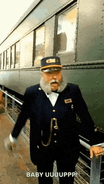 a man with a beard and mustache is standing next to a train car .