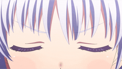 a close up of a person 's eyes with a purple hair